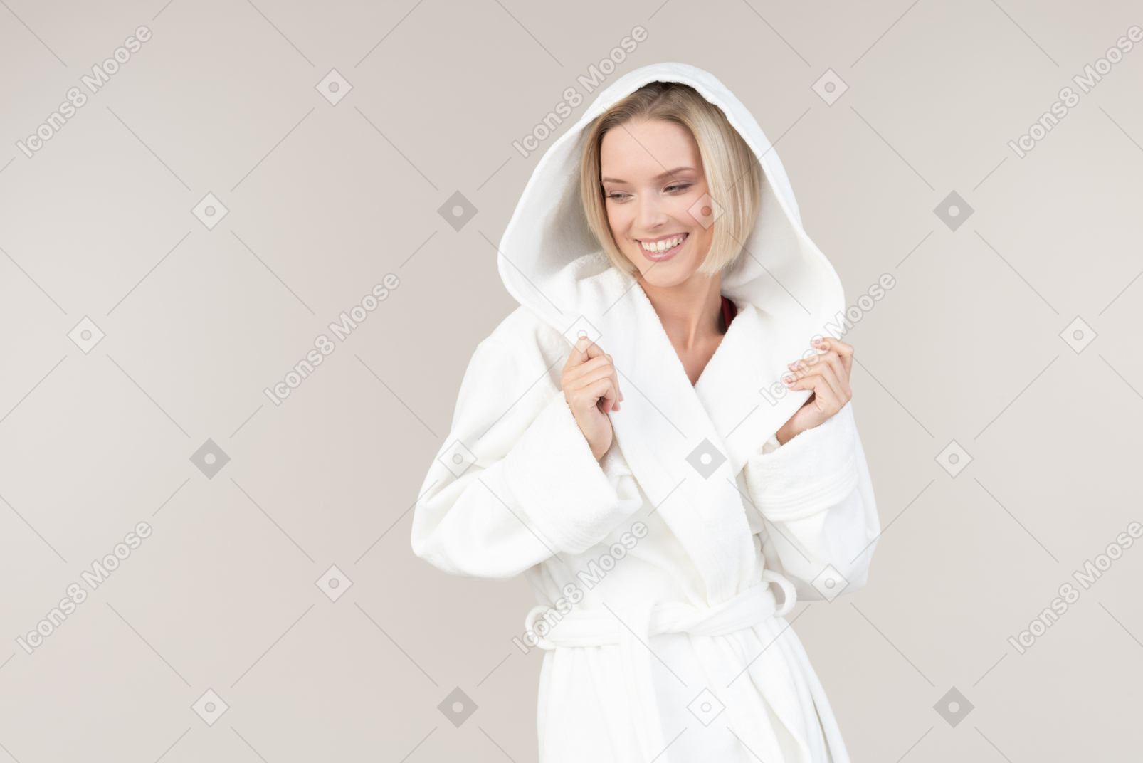 Young woman in bathrobe standing halfsideways