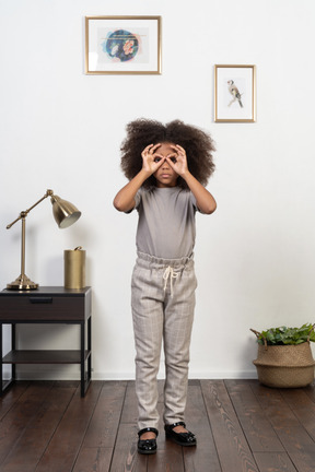 Good looking girl kid posing on the apartment background