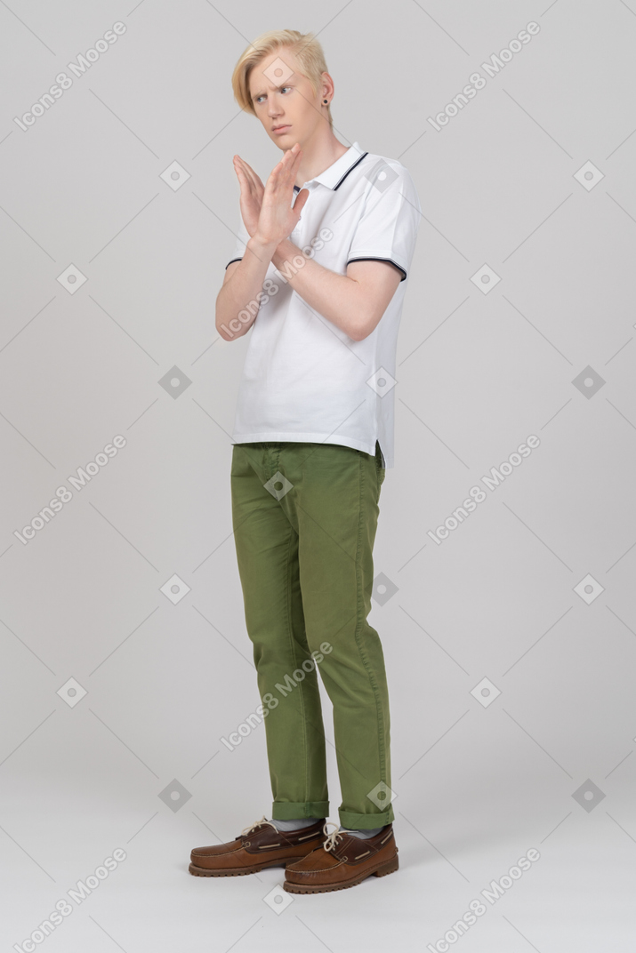 Young man crossing arms