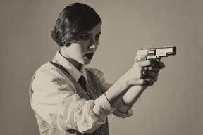 Woman holding a gun with both hands