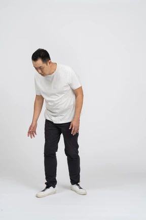 Front view of a confused man looking down
