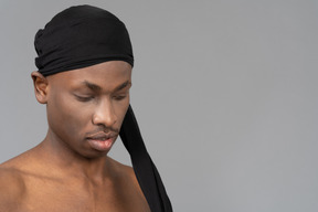 Young man with black tights on his head