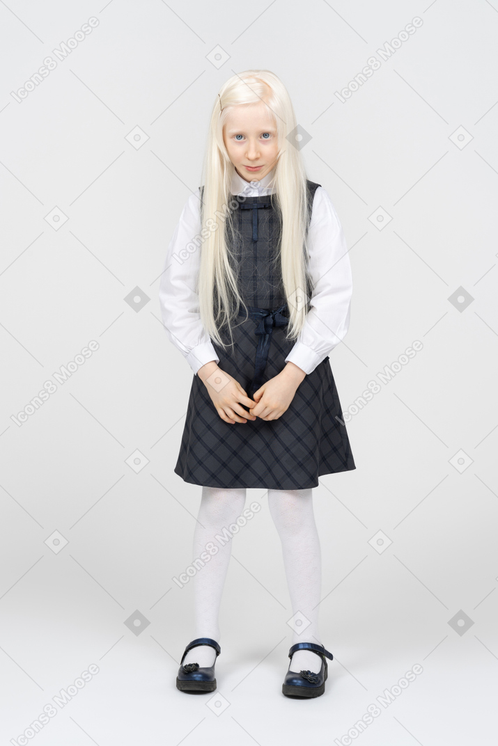Schoolgirl with platinum blonde hair looking shy