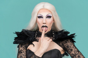 Drag queen sticking finger in open mouth