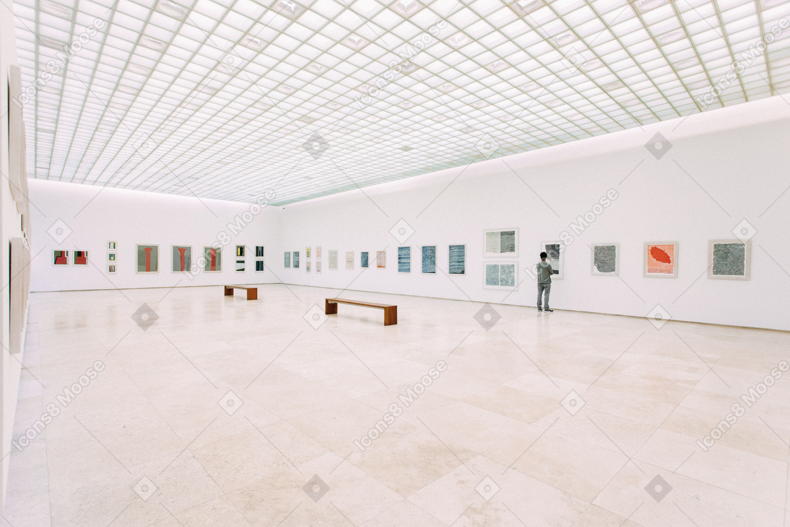 Spacious white hall with pictures on it