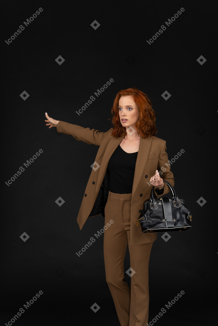 Young businesswoman hailing a taxi
