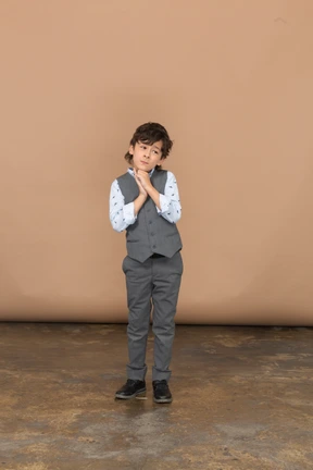 Front view of a cute boy in grey suit