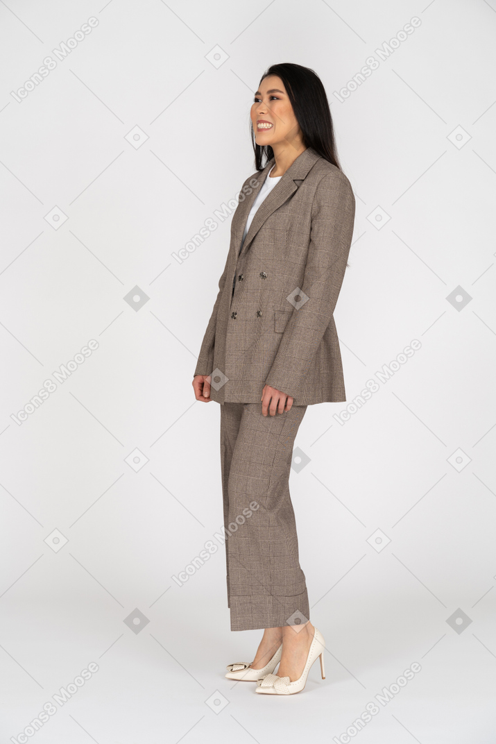 Three-quarter view of a smiling young lady in brown business suit