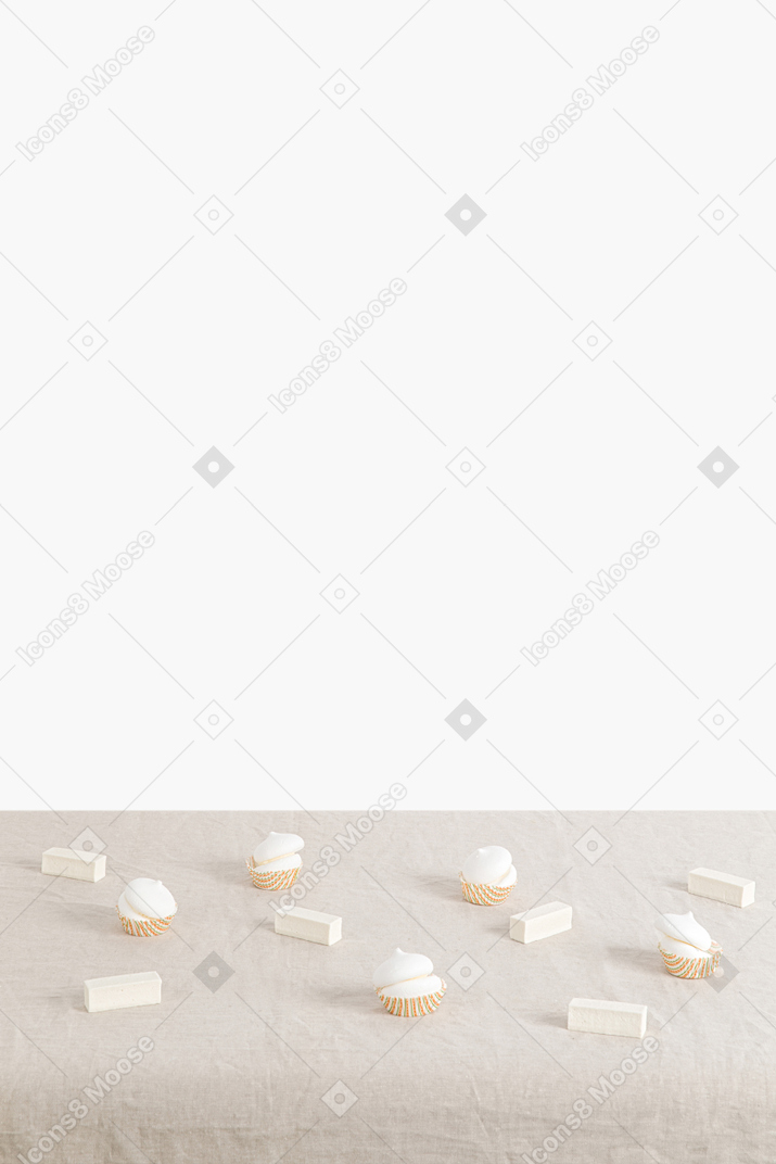 Scattered zephyrs and marshmallows on a canvas tablecloth