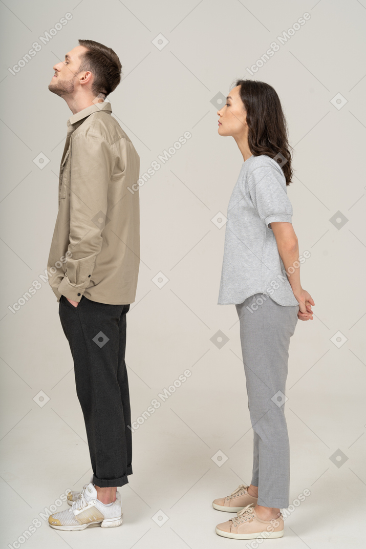 Side view of couple pulling their necks