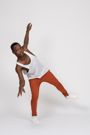 Young man balancing on one leg