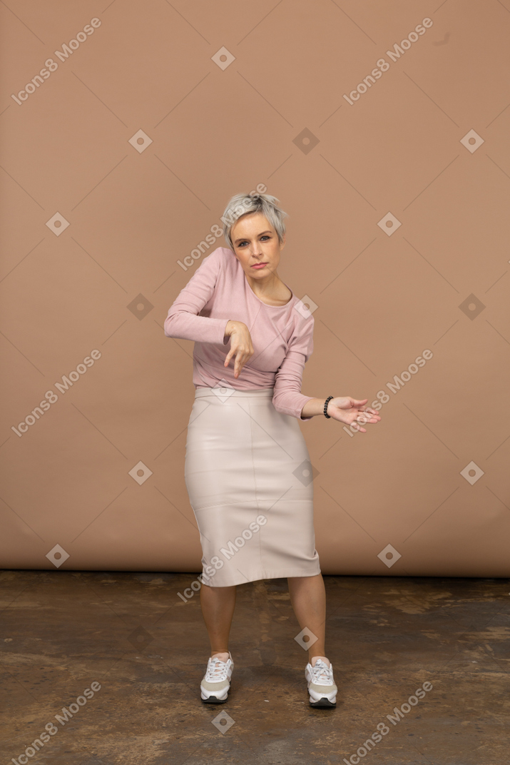 Front view of a woman in casual clothes dancing