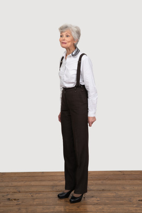 Vista di tre quarti di una donna anziana vestita con abiti da ufficio