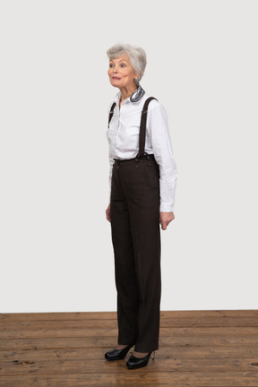 Three-quarter view of an old female dressed in office clothes