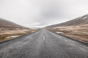 Empty road under a gray sky