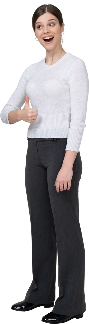 Three-quarter view of a cheerful young woman in office clothing showing thumb up