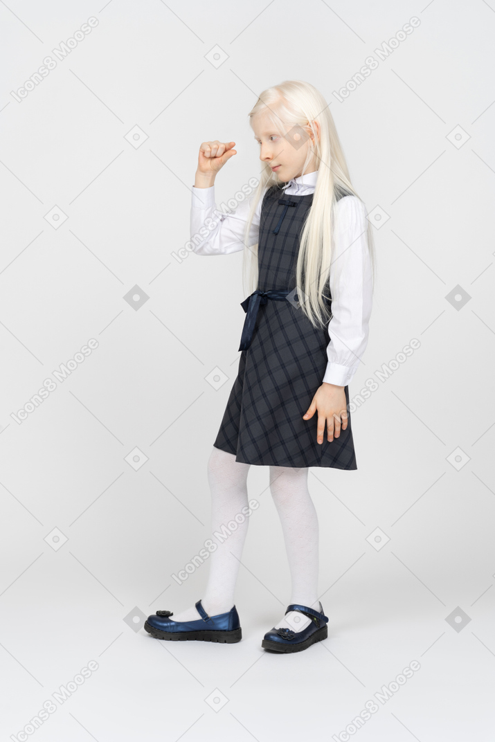 Schoolgirl showing the size of something small
