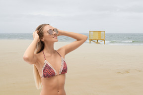 A woman in a bikini standing on a beach