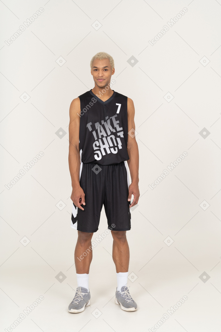 Front view of a young male basketball player standing still & smiling