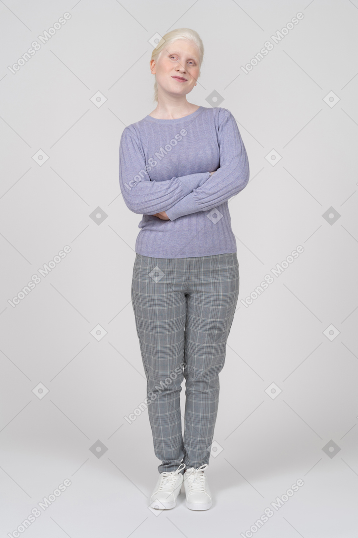 Confident young woman standing with arms crossed