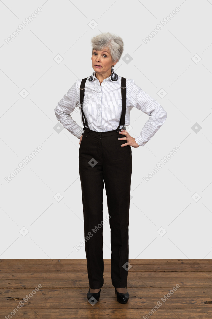 Full-length of an old questioning  female in suspenders putting hands on hips