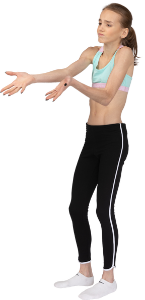Three-quarter view of a displeased teen girl in sportswear outstretching hands
