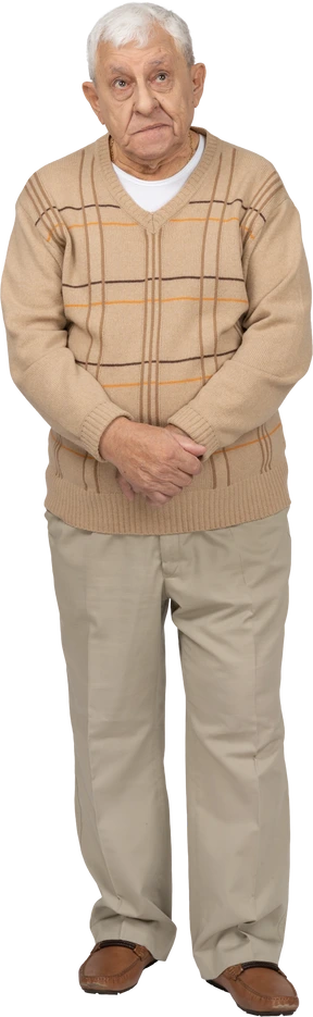 Front view of an old man in casual clothes looking up