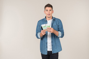 Young stand-up comic holding banknotes