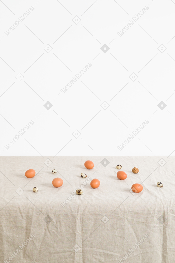 Chicken and quail eggs on a white tablecloth