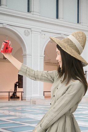 Donna che prende selfie in un museo