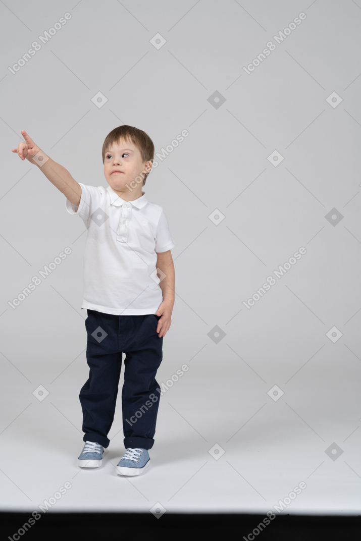 Front view of little boy pointing left