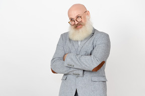 Smiling mature professor standing with his hands folded