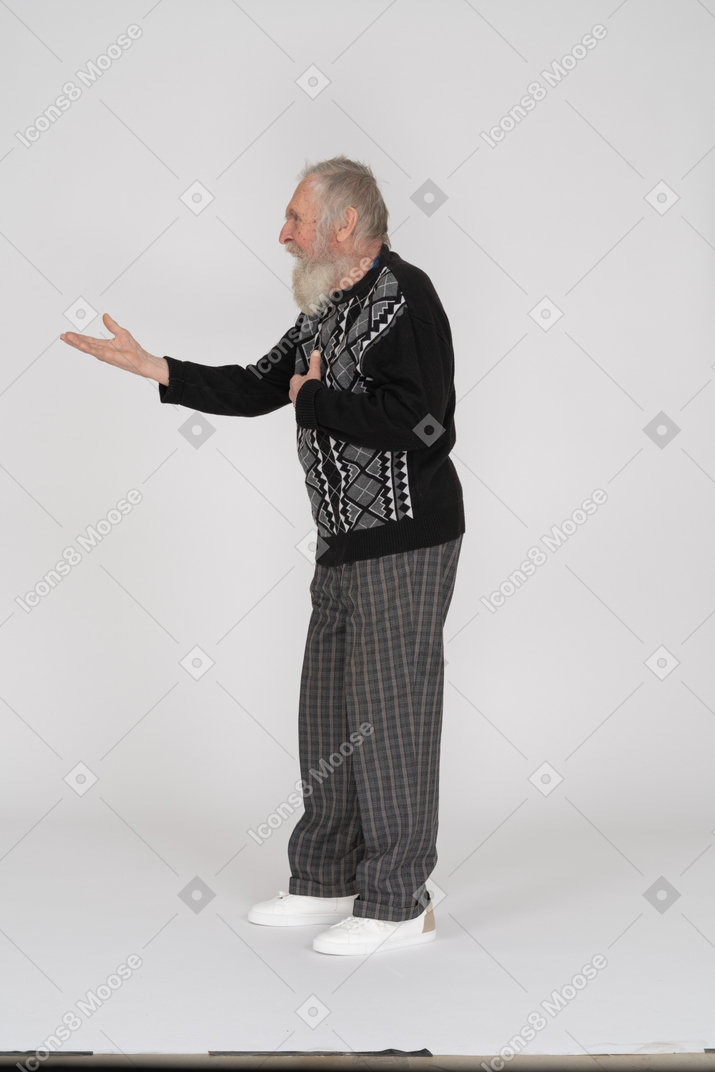 Side view of an elderly man outstretching his arm