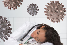 Female doctor sleeping while being attacked by viruses