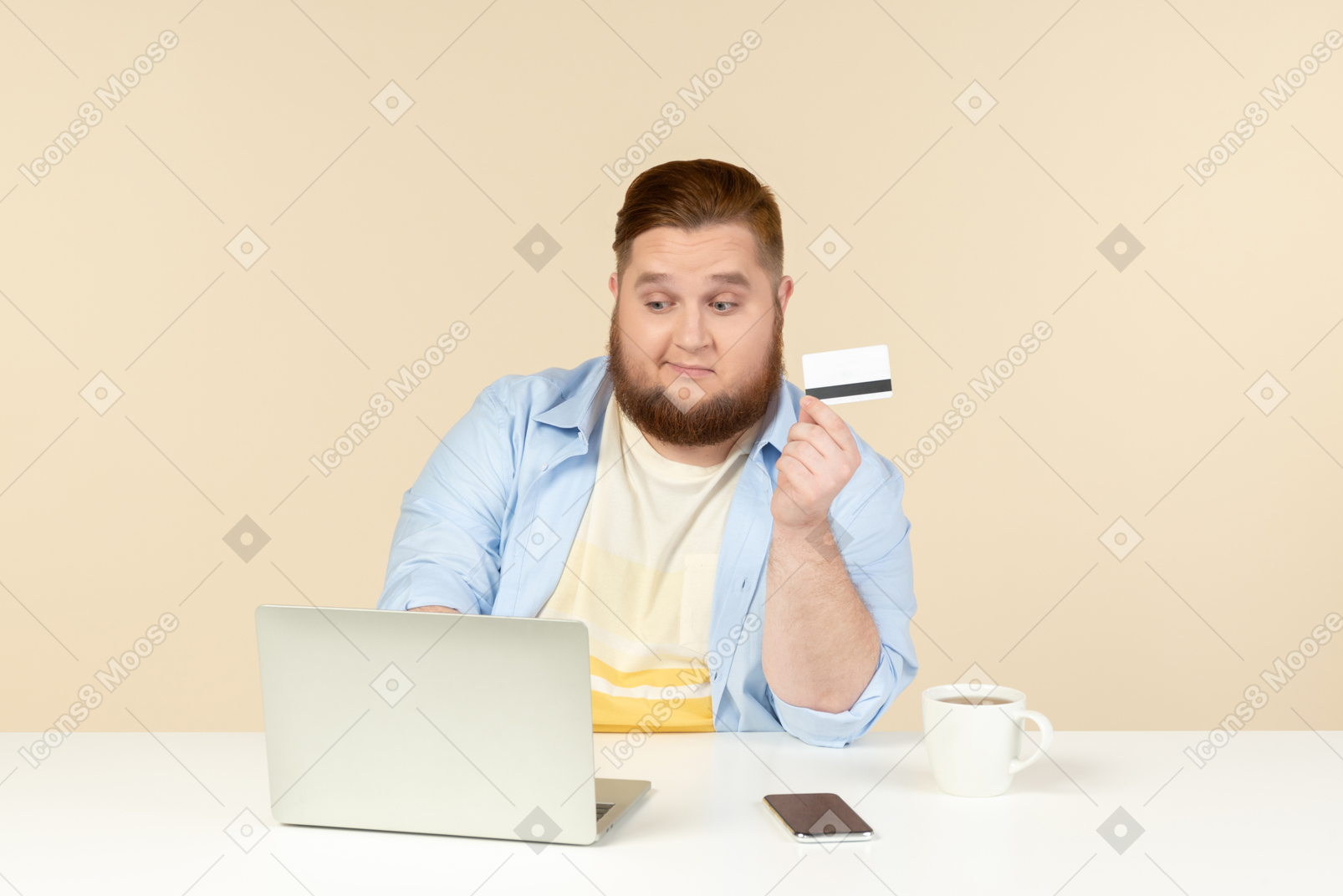 Doubtful young overweight man sitting at the office desk and doing online shopping
