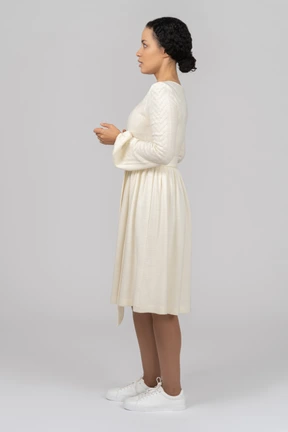 Surprised young woman standing sideways to camera