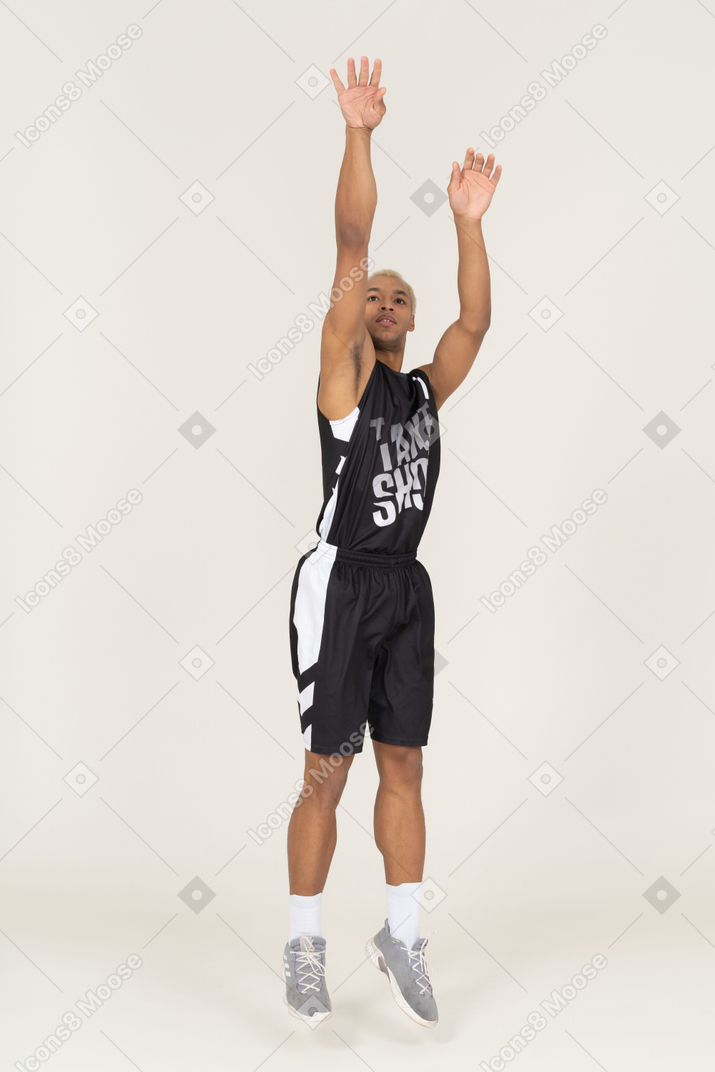 Front view of a young male basketball player throwing something