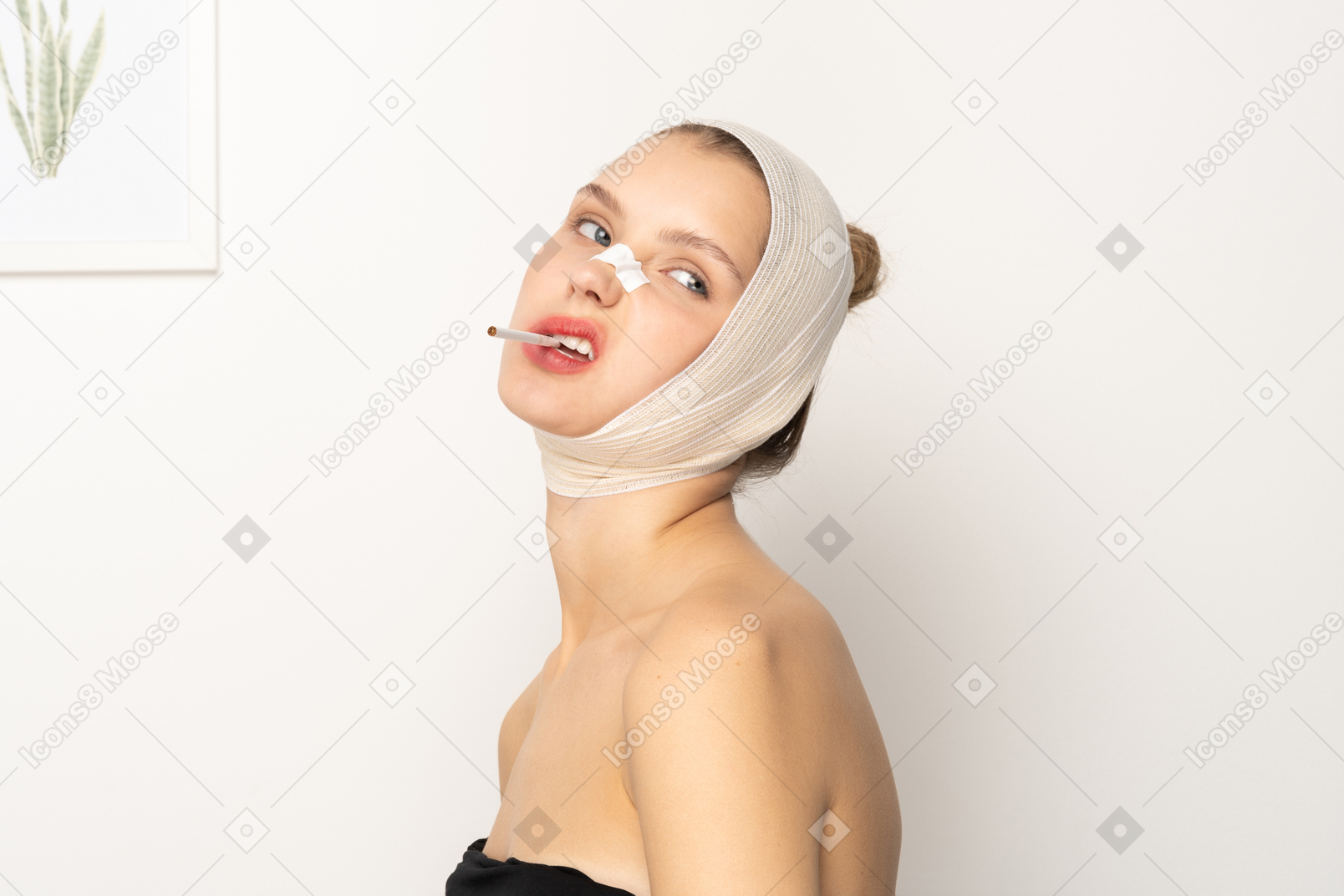 Young woman with head bandage and cigarette in her mouth