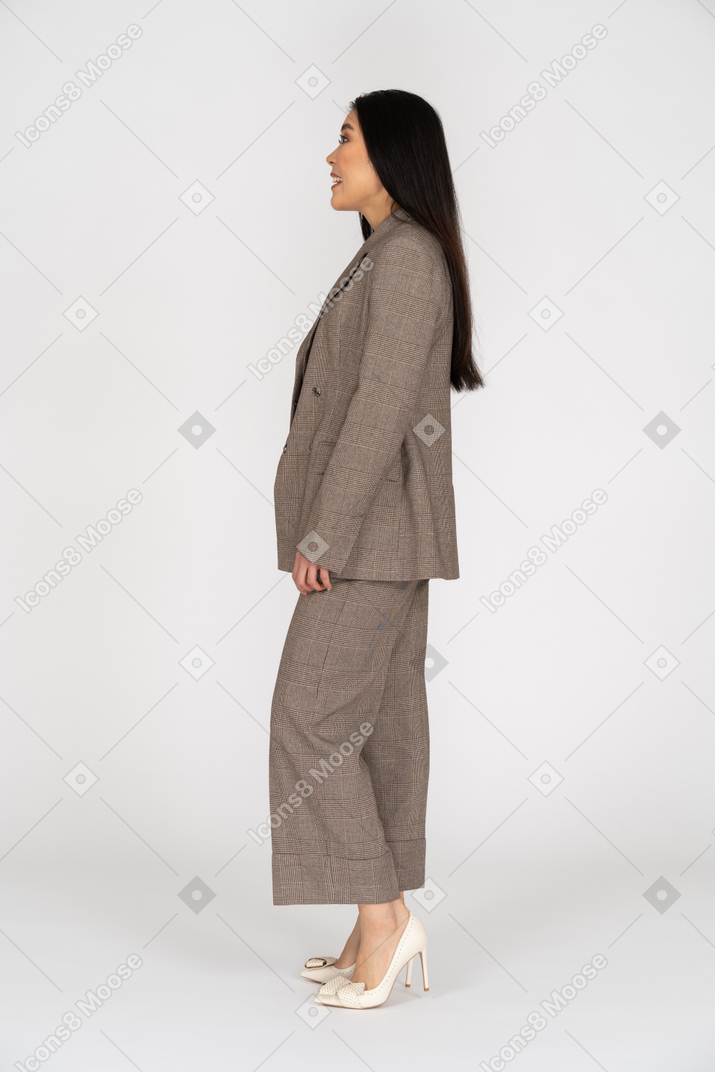 Side view of a surprised young lady in brown business suit