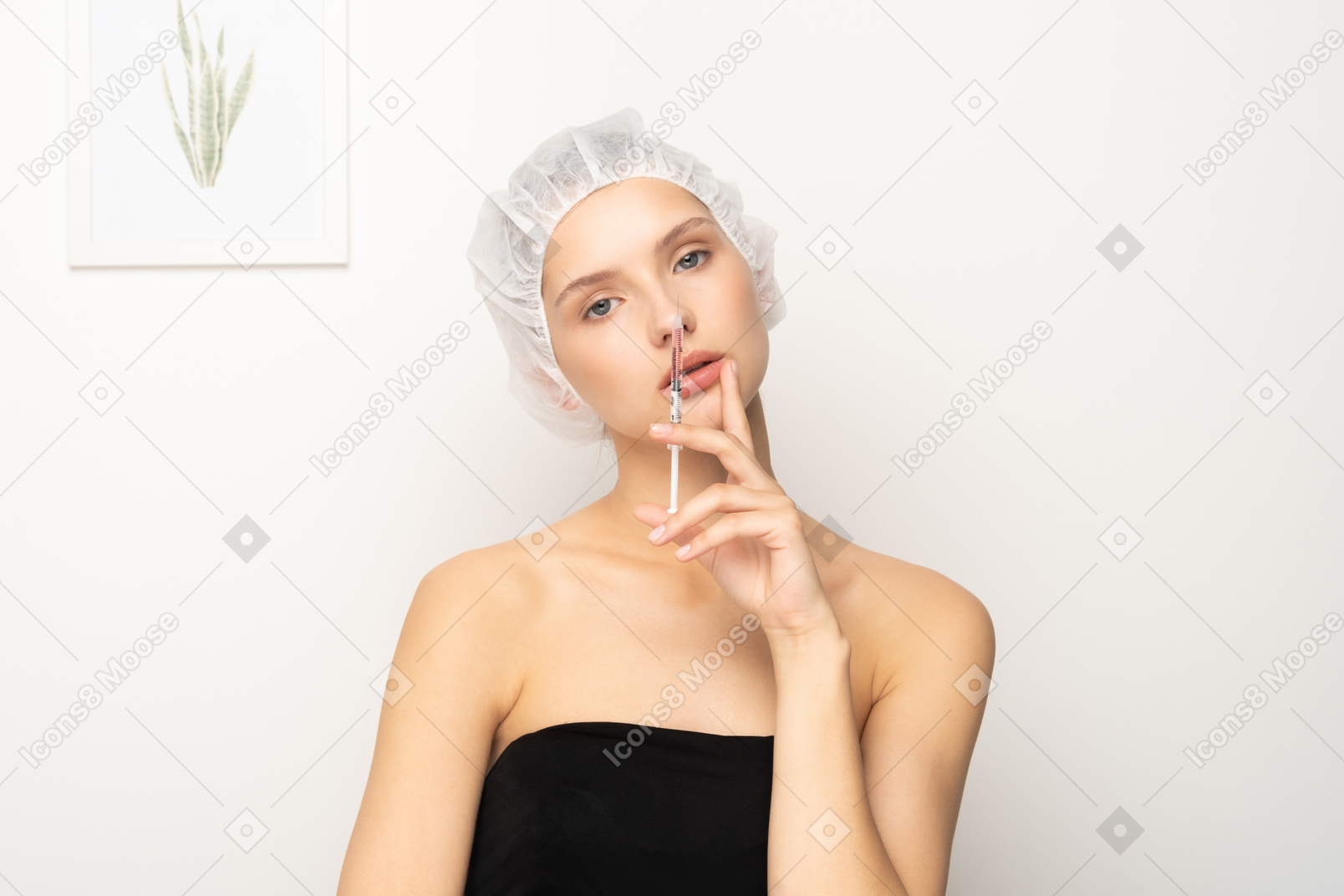 Woman standing with syringe and looking at camera