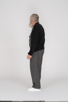 Elderly man standing and facing away from camera