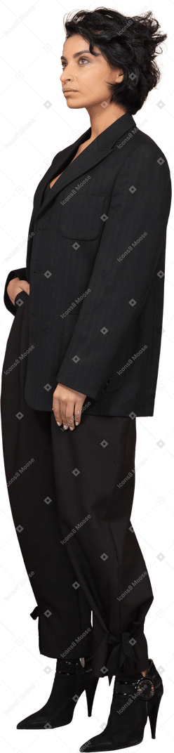 Three-quarter view of a businesswoman in a black suit looking up