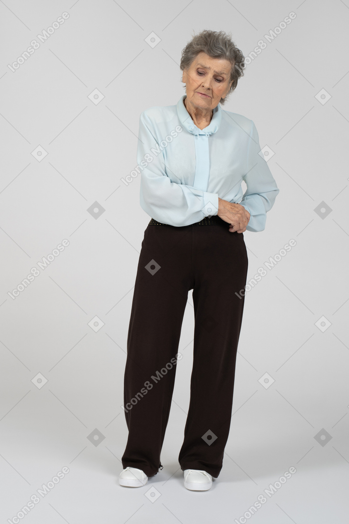 Front view of an old woman looking down melancholically