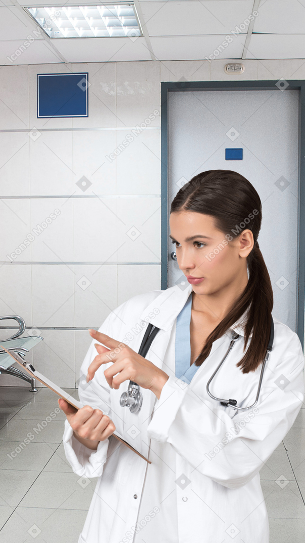 A woman in a white lab coat holding a clipboard