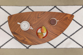 Coffee table with a tea set and fruits in the style of 60s