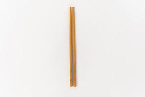 Wooden chopsticks on white background