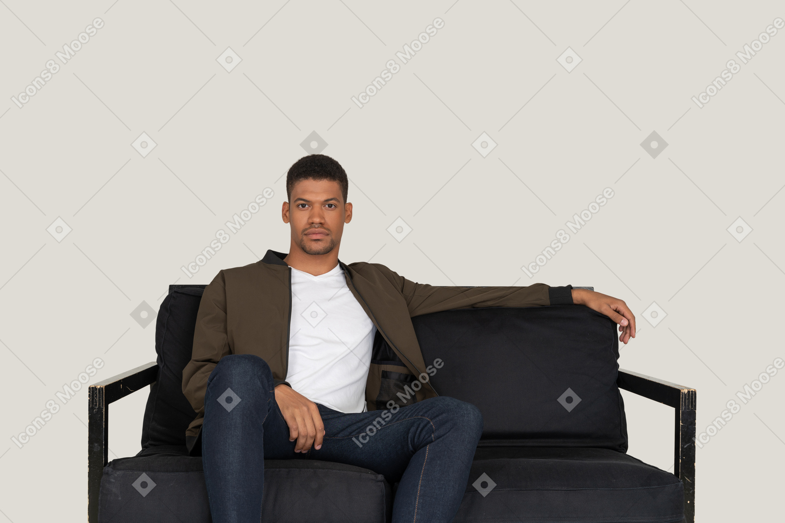 Smiling young man sitting on the sofa