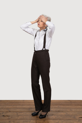 Three-quarter view of a tired old lady in office clothing