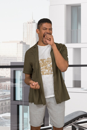 Man standing in front of a window and laughing