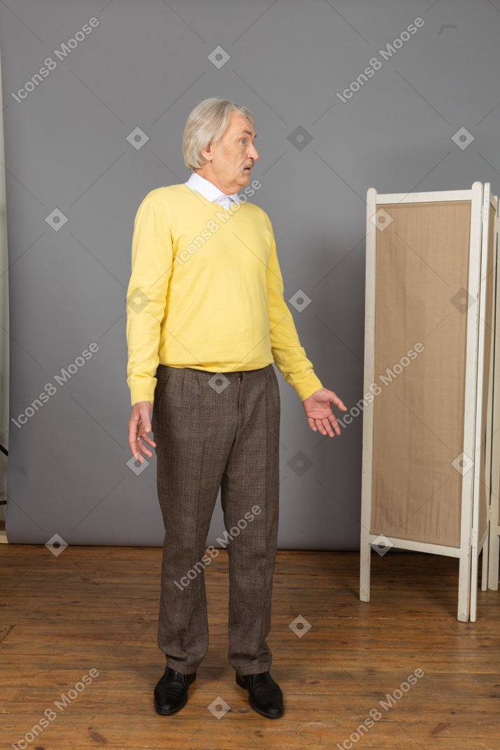 Front view of a questioning old man turning around